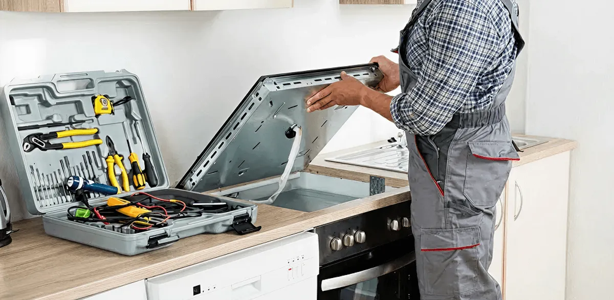 Handyman repairing a cooktop and checking wiring connections in Cincinnati, OH