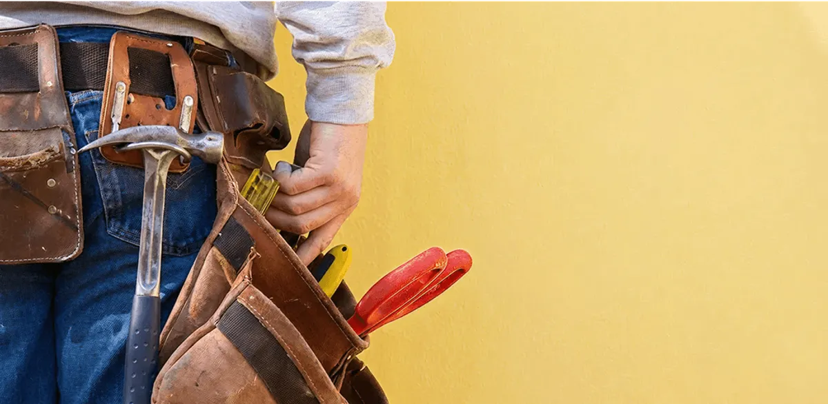 Handyman with tool belt ready for home repairs and maintenance in Cincinnati, OH