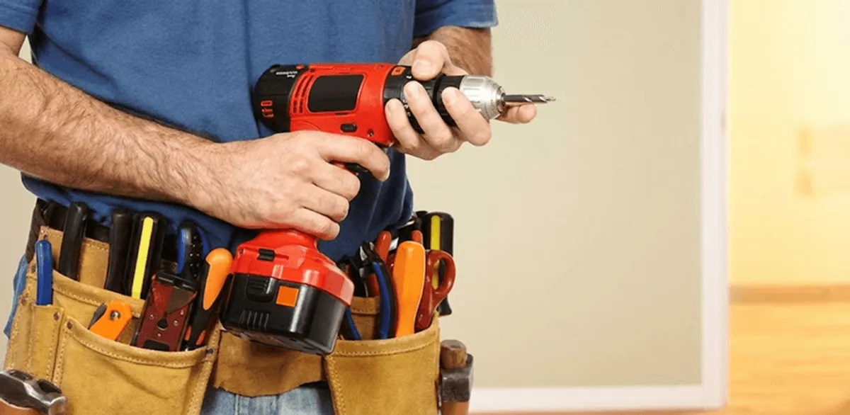 Handyman holding a power drill for home repairs and installations in Cincinnati, OH